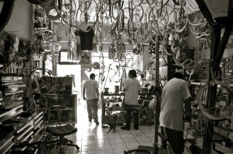 Stalin, Hugo, and an apprentice at the Watts Cyclery keep Watts moving for as little money as possible. Their adult customers cycle out of necessity and can often barely afford to keep their bikes moving. Sahra Sulaiman/Streetsblog L.A.