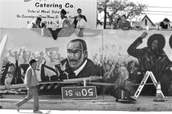 The Crenshaw Wall tells the story of the community's resilience, strength, beauty, and power. Someone covered the faces of four female Black Panthers (one of which is in the frame) with swastikas on November 29th. The streetlight was down to make way for the Space Shuttle Endeavor as it moved up Crenshaw in 2012.  Sahra Sulaiman/Streetsblog L.A.
