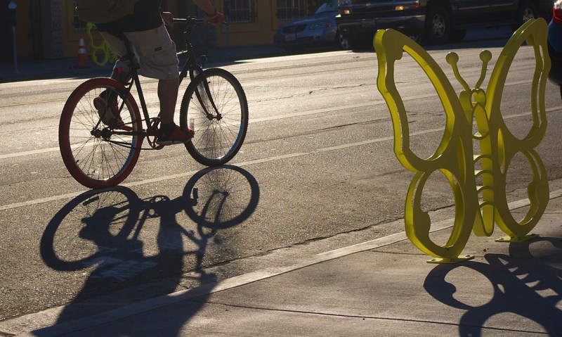 A cyclist speeds past a butterfly on 1st St. in Boyle Heights. Sahra Sulaiman/Streetsblog L.A.