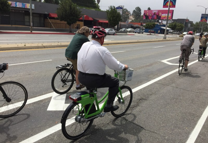 In response to lawsuits mostly not in bike lanes, Councilmember Englander has proposed removing bike lanes. Photo of Councilmber Koretz riding a cracked-pavement Fairfax Avenue bike lane in 2016 - by Joe Linton/Streetsblog L.A.