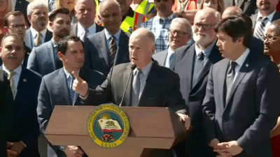 Governor Jerry Brown, flanked by Assembly Speaker Anthony Rendon and Senate President Pro Tem Kevin de León, with S.B. 1 author Senator Jim Beall looking on, touts the new transportation funding agreement.