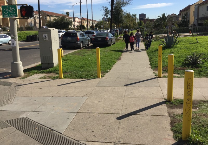 Anti-parking posts like these (which didn't prevent the car from its spot) are proliferating in Koreatown. All photos: Joe Linton/Streetsblog L.A.