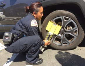 An LADOT parking officer demonstrates the new smart boot. Photo: Joe Linton/Streetsblog L.A.