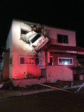 No, it's not an art piece: the driver of this car really did fly it into the building. Image: Orange County Fire Authority Public Information Officer Twitter Page