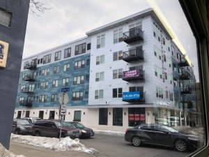 This 70-unit apartment building was built after Minneapolis relaxed its parking requirements. It still has parking, but only surface spots, not the costly underground garage that the old rules would have required. Photo: Nick Magrino