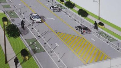 Orlando will repurpose car lanes to create protected bike lanes and safer pedestrian crossings for a trial project on Curry Road. Rendering: City of Orlando