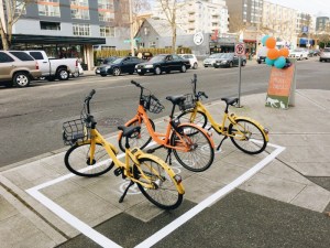 So close, Seattle! The city is reserving space for dockless bike-share parking on the sidewalk, not the curb lane. Photo: Seattle DOT