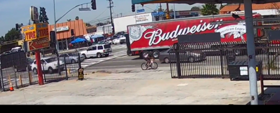 In security footage released by the LAPD, Frederick "Woon" Frazier is seen turning right into the empty gutter lane on Manchester moments before a white SUV is seen speeding into frame behind him.