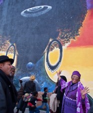 In January, 2012, community members "cruise[d] Afro-central down the River Crenshaw," as poet Conney Williams' verse reads, to the base of "Elixir." The brief pilgrimage along the corridor from Coliseum to Stocker for the dedication of Patrick Henry Johnson's mural honored the connections between people, place, and the creative process. Williams read his poem, "Elixir," as part of the dedication ceremony. Sahra Sulaiman/Streetsblog L.A.