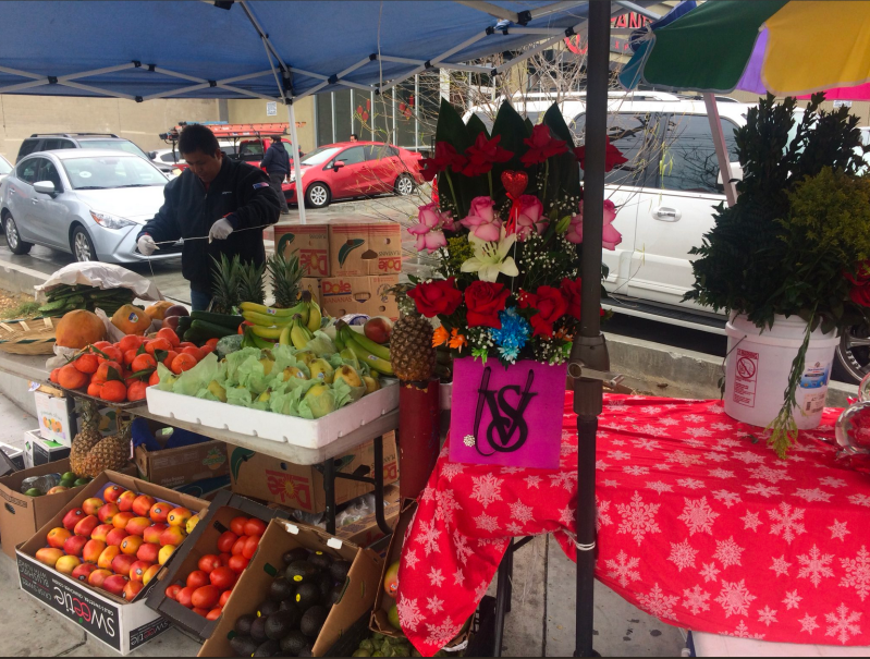 A street vendor on Whittier and Soto packs up his goods after being asked to move by LAPD. Image courtesy Antonio Mejías-Rentas