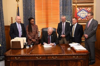 Arkansas Governor Asa Hutchinson signs Idaho Stop Legislation. Photo courtesy of Arkansas State Parks