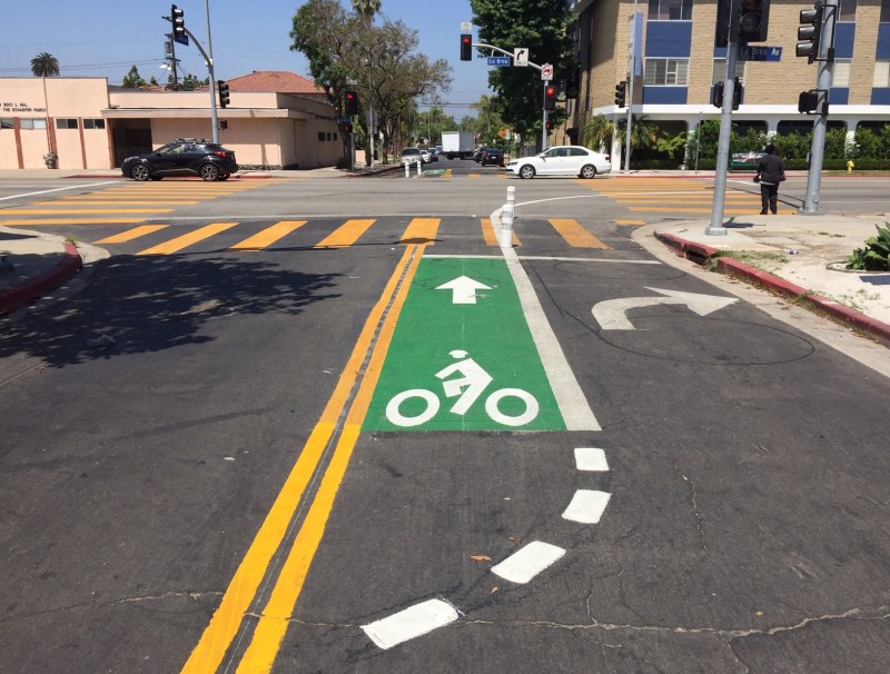 Rosewood Avenue's diverter now has green pavement and bollards. Photos by Joe Linton