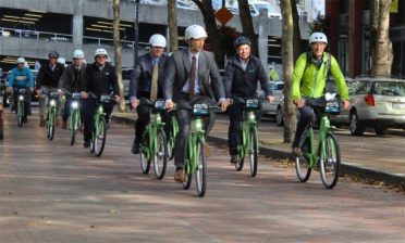 No state currently mandates helmet use by adults (but politicians love them for photo ops). Photo: Seattle Office of the Mayor