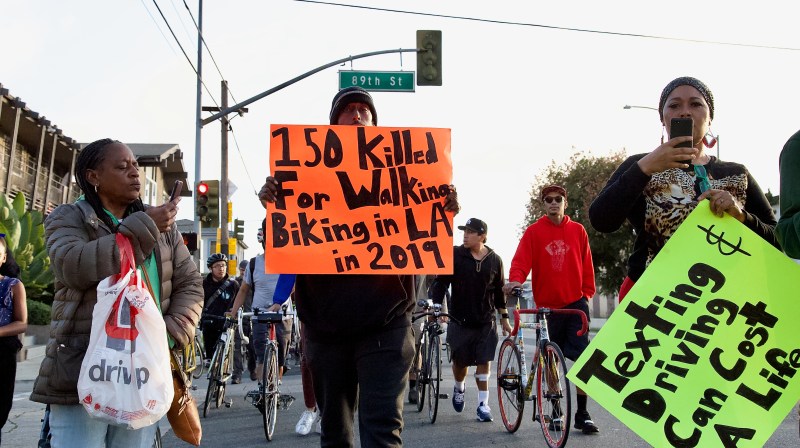 Friends and supporters of Frederick "Woon" Frazier march up Normandie to honor his memory and ask for the city to slow their streets down. All photos by Sahra Sulaiman/Streetsblog L.A.