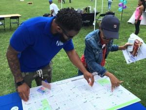 Vision Zero ambassador DeAndre Bingham and a resident discuss barriers to safe walking and biking at a West Side block party. Photo: CDOT