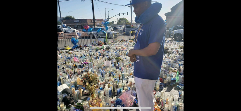 Jermaine Welch mourns the loss of rapper, artist, entrepreneur, and visionary Nipsey Hussle in this image from 2019. While out making deliveries just after midnight on June 3, Welch passed through an intersection on Broadway, just south of Manchester, and was shot six times, possibly by the LAPD. He has been under investigation ever since. Image courtesy Jermaine Welch.