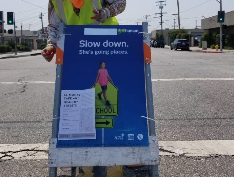 "Slow Streets" are streets redesignated for local traffic only to give more space for people to walk/bike/skate/exercise with social distancing. Slow streets are spreading due to both more funding through Metro and SCAG. Pictured here is a slow street opening in El Monte. Image via Active SGV.