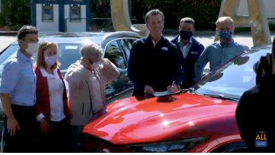Governor Newsom signing executive order to phase out fossil fuel vehicles in California, on an electric car. Image: Screengrab from YouTube