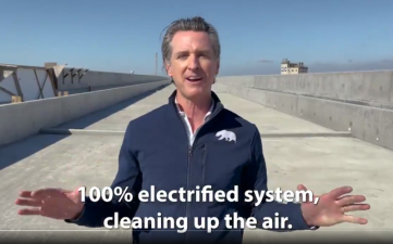 From a promotional video shot by Gavin Newsom's office. In this frame, he is standing on a bullet train viaduct in the Central Valley extolling the virtues of non-polluting, electrified trains. Image from March 2021