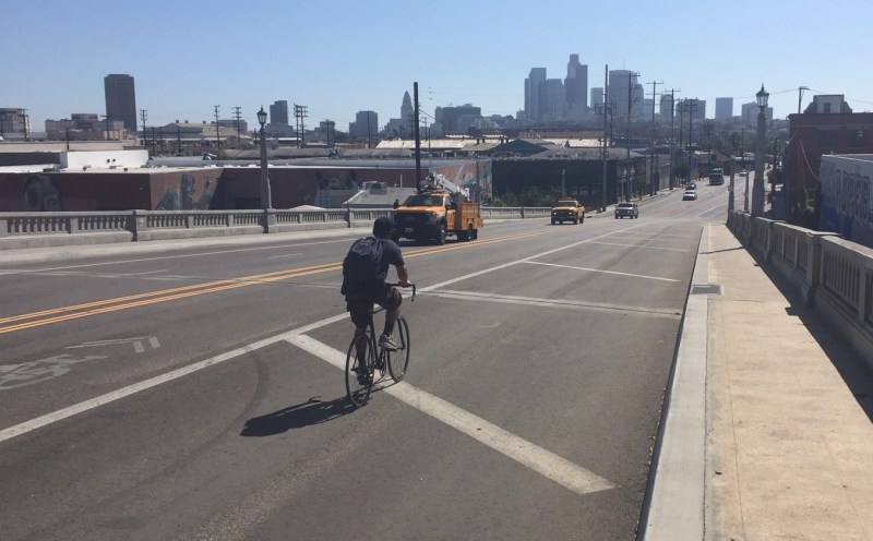 The North Spring Street Bridge yesterday: no bike lanes. Cyclist rides in the area striped off for construction that hasn't taken place for months. Photo by Joe Linton/Streetsblog L.A.
