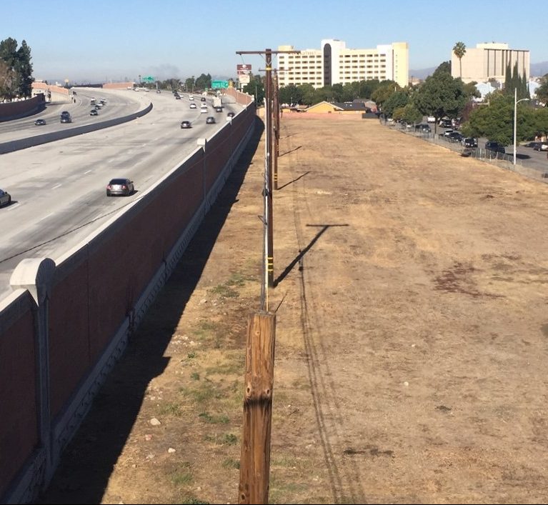 This vacant land, viewed from Norwalk's Silverbow Avenue pedestrian overpass, was more than a dozen homes. Metro and Caltrans have demolished hundreds of homes for their South 5 Freeway widening project. Photo by Joe Linton/Streetsblog L.A.