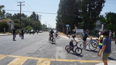 Cyclists arrive at a stop on Fifth Ave and Lomitas Ave to hear an activist speak on a toxic tour in Avocado Heights. Credit: Chris Greenspon/Streetsblog